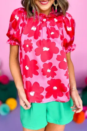 Blouse fleurie rose à manches bouffantes et encolure à volants